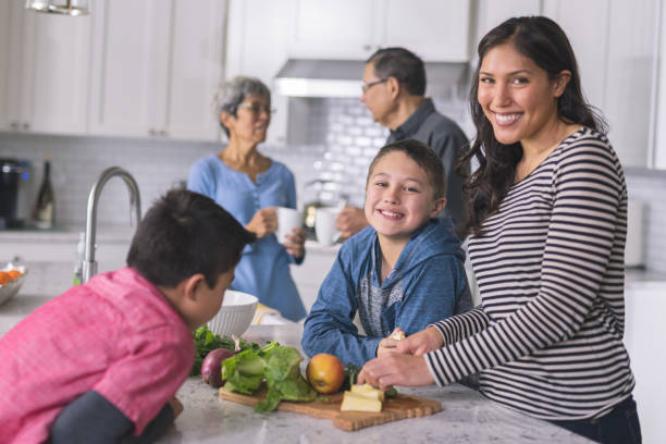 istock Three generations of family making lunch together in a modern kitchen 1161275994