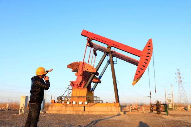 istock oil field, the oil workers are working 1161284776