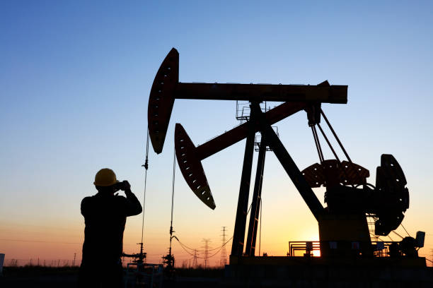 istock oil field, the oil workers are working 1161285303