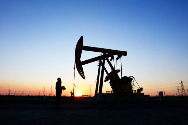 istock oil field, the oil workers are working 1161285315
