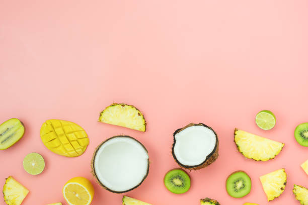 istock Table top view fruit tropical with spring summer holiday & vacation  background concept.Arrangement sliced various pineapple kiwi mango lemon and lime coconut on  pink paper.flat lay & copy space. 1161293009