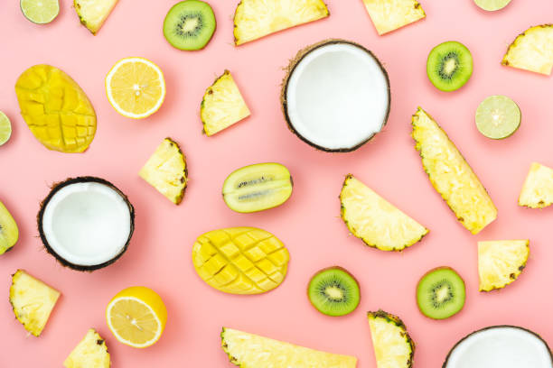 istock Table top view fruit tropical with spring summer holiday & vacation  background concept.Arrangement sliced various pineapple kiwi mango lemon and lime coconut on  pink paper.flat lay & pastel tone. 1161293012