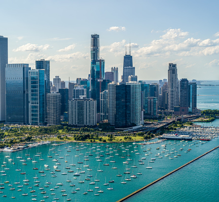 Aerial View of Downtown Chicago and Lake Shore in Summer flying over Lake Michigan