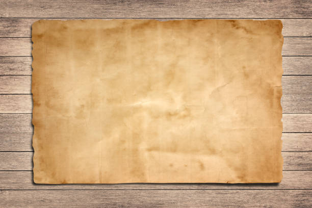 istock Old paper on the wood background 1161296618