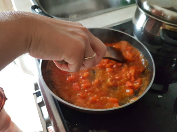 istock frying pan cooking tomato sauce for omelette of eggs and cheese 1161300476
