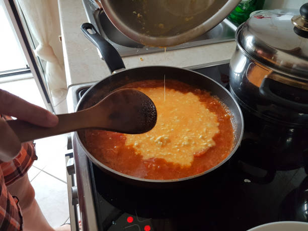 istock frying pan cooking tomato sauce for omelette of eggs and cheese 1161301368