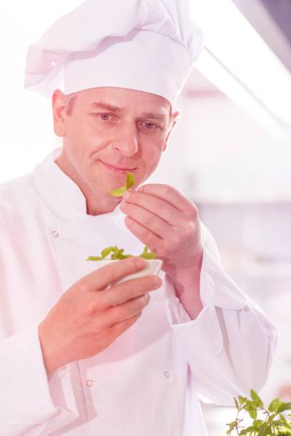 istock Smiling blond woman eating while sitting with man at table in restaurant 1161302589
