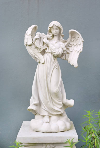 istock Beautiful angel statue against gray wall background. 1161302771