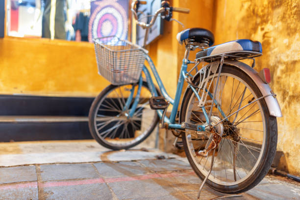 istock Blue vintage style bicycle parked at yellow wall, Hoi An 1161304742