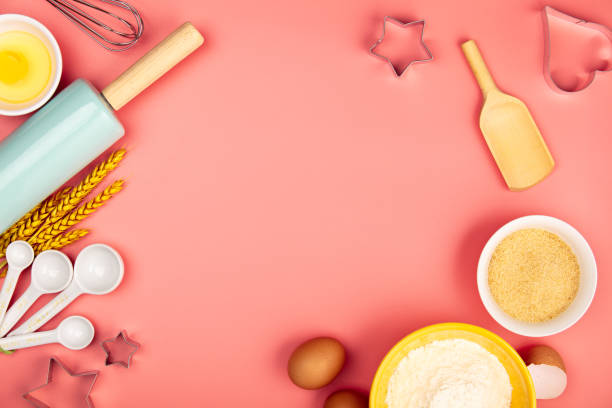 Baking or cooking ingredients on pink background, flat lay