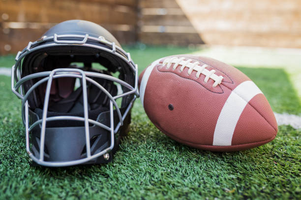 istock Rugby helmet with ball on green grass 1161305688