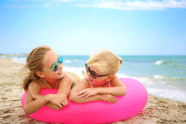 Father and daughters playing in the ocean. Blue sky in the background, copy space. Boca Raton, Florida.