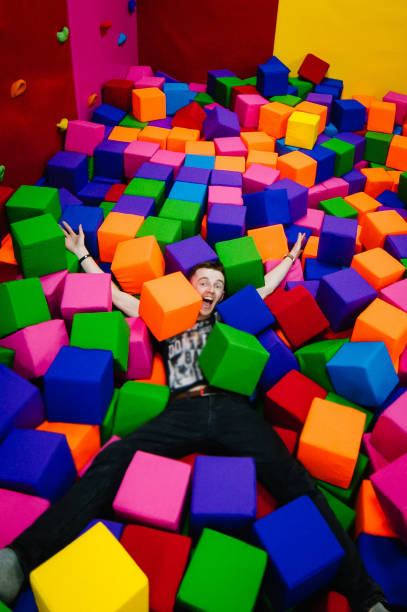 istock A young man or boy, father playing and falls in soft cubes in th 1161312159