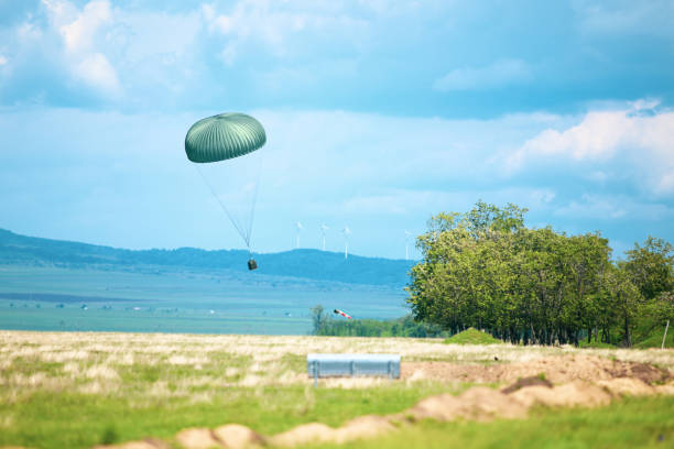 istock A military crate is being parachuted from a military cargo plane during a drill. 1161312450