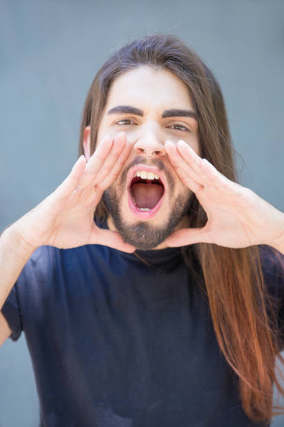 istock Handsome bearded young man announcing news 1161313624