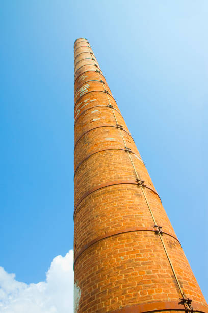 istock Old brick chimney isolated on sky with metal reinforcements 1161314506
