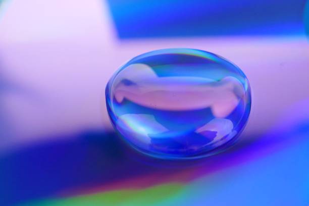 istock Drop macro background.Water drop on a deep blue iridescent background with gradation and highlights. Abstract blob texture background.Phone wallpaper 1161319910