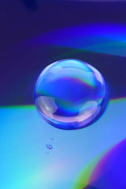 istock Drop macro background.Water drop on a deep blue iridescent background with gradation and highlights. Abstract blob texture background. 1161319911