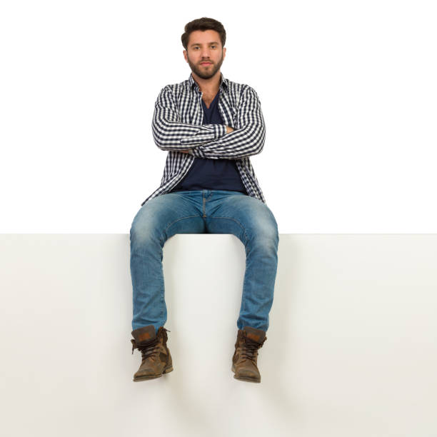 istock Serious Handsome Man Is Sitting On A Top With Arms Crossed 1161321310