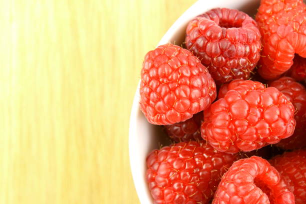 istock fresh red raspberry fruits in a small white bowl 1161322975