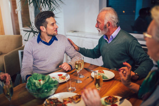 istock Multi generation family enjoying meal around table at home 1161324231