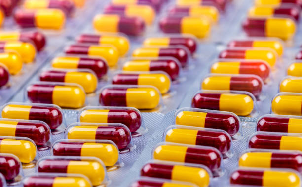 cápsula de color rojo-amarillo en el blíster. píldoras de cápsulas de antibióticos. resistencia a los medicamentos antimicrobianos. medicamentos para la penicilina para la infección por tratamiento. medicamentos para matar bacterias. industria farmac - amoxicillin fotografías e imágenes de stock