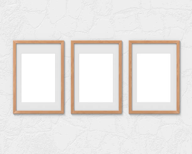 istock Set of 3 vertical wooden frames mockup with a border hanging on the wall. Empty base for picture or text. 3D rendering. 1161326270