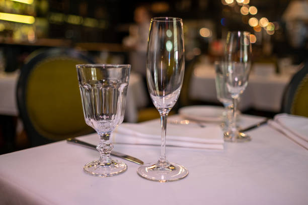 istock Natural light or daylight shot of modern restaurant table set for a lunch. Shallow focus on wine glass. Empty glasses set in restaurant. 1161326830