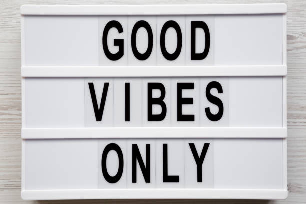 istock 'Good vibes only' words on a modern board on a white wooden surface, top view. From above, overhead, flat lay. Close-up. 1161328127