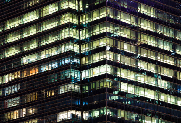 istock Late night overtime in a modern office building 1161328159