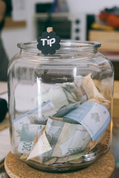 istock tip money place on the glass 1161328845