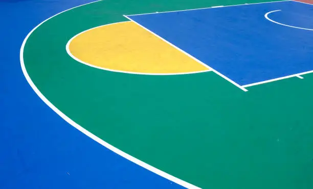 Photo of colorful outdoor rubber basketball playground detail aerial view