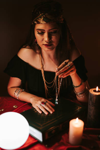 istock Fortune teller and book of charms 1161331274