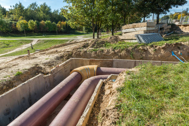istock Underground pipe installation. Underground utility and services pipe lay at the construction site. 1161331644