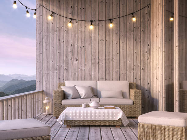 Wooden balcony with mountain view 3d render Wooden balcony with mountain view 3d render, The floor and walls are old wood, decorated with fabric and rattan furniture. Decorated with string lights. modern cottage interior design stock pictures, royalty-free photos & images