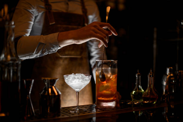 istock Professional bartender stirring a cocktail in the measuring glass cup 1161335984