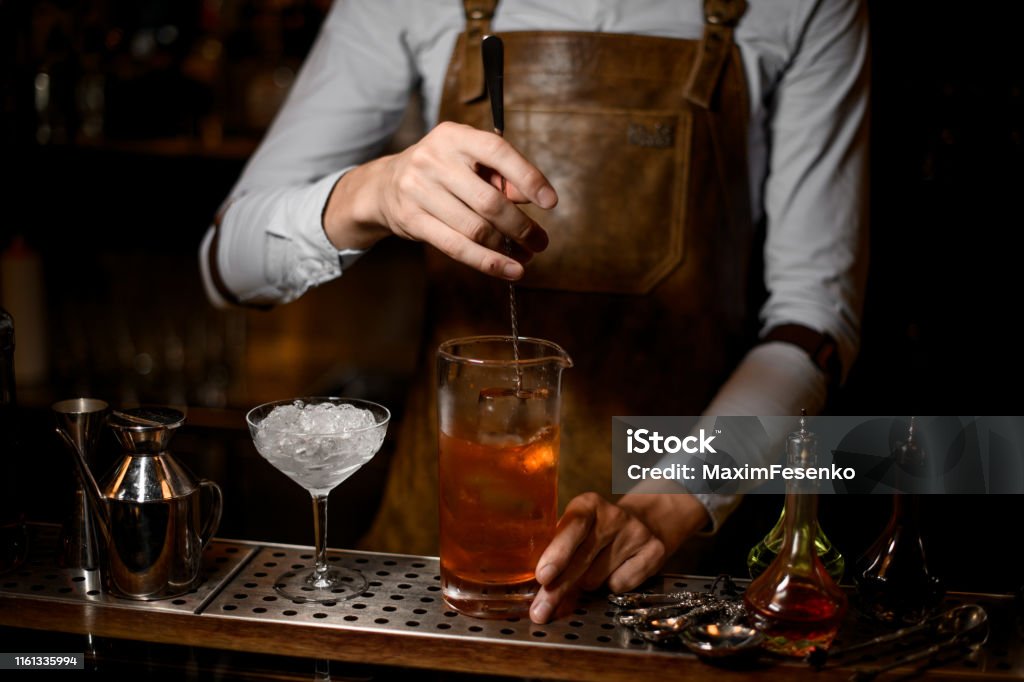 Bartender Stirring A Delicious Cocktail In The Measuring Glass Cup