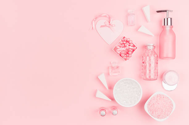 istock Spring fresh cosmetic products for makeup and bath in pastel pink color as decorative border, top view. 1161336344