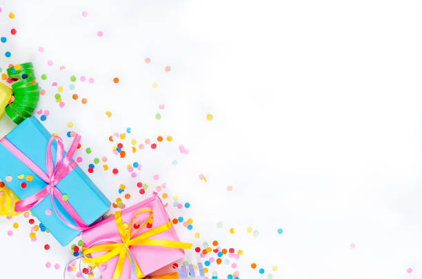 istock Colorful assorted confetti with serpentine and gift boxes on white 1161337533
