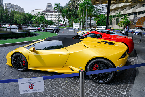 Pattaya, Thailand - May 26 2019 : Yellow Lamborghini sport cars of famous brand parking on front of the Royal Cliff Beach Hotel