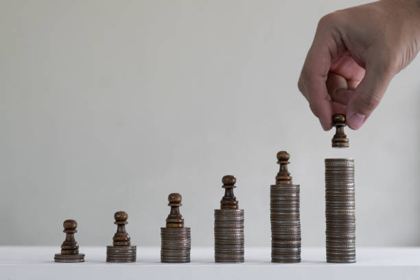 istock Coin stacks arranged into growth chart with chess pieces on white background, finance and business concept, copy space 1161339686