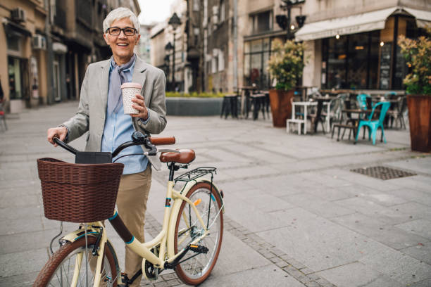 istock Woman walking by bicycle and drinking coffee 1161341146