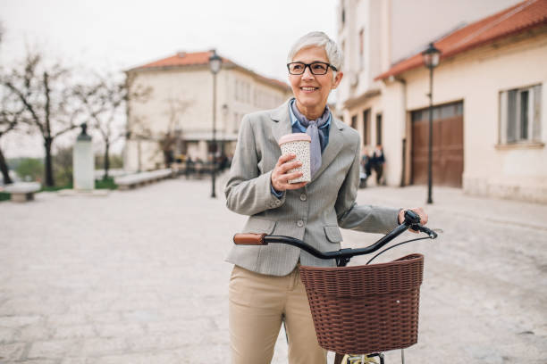 istock Woman standing by her bicycle 1161341148