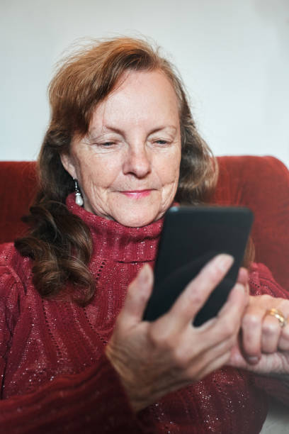 istock Smiling senior woman confidently using smart phone 1161341575