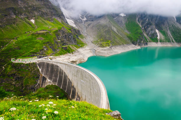 istock Hydroelectric power station along cloudy mountains 1161342823