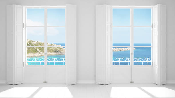 istock Stylish empty room with panoramic windows close-up, classic shutters, classic balcony. Sea landscape, granite rocks. White background with copy space, interior design concept 1161343195