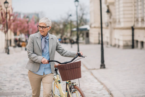 istock Woman pushing bicycle 1161344318