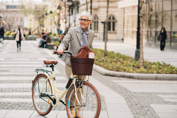 istock Mature woman pushing bicycle 1161344404