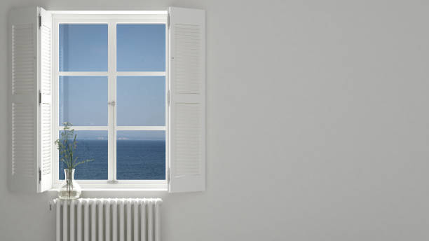 istock Stylish empty room with panoramic window close-up, classic shutters, glass vase with flowers. Sea landscape, sailboat. White background with copy space, interior design concept 1161344496