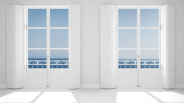 istock Stylish empty room with panoramic windows close-up, classic shutters, classic balcony. Sea landscape, granite rocks. White background with copy space, interior design concept 1161344579